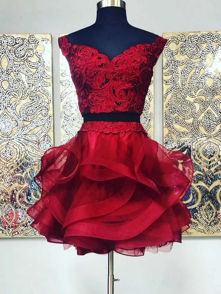 Model wearing a two-piece lace short prom dress with a V-neckline.