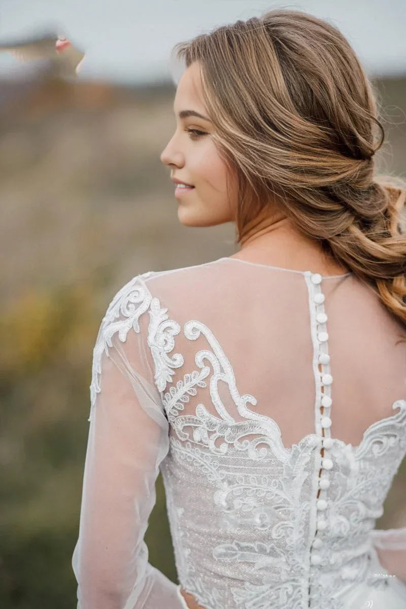 Bride in a V-neck two-piece bohemian wedding gown with lace details.