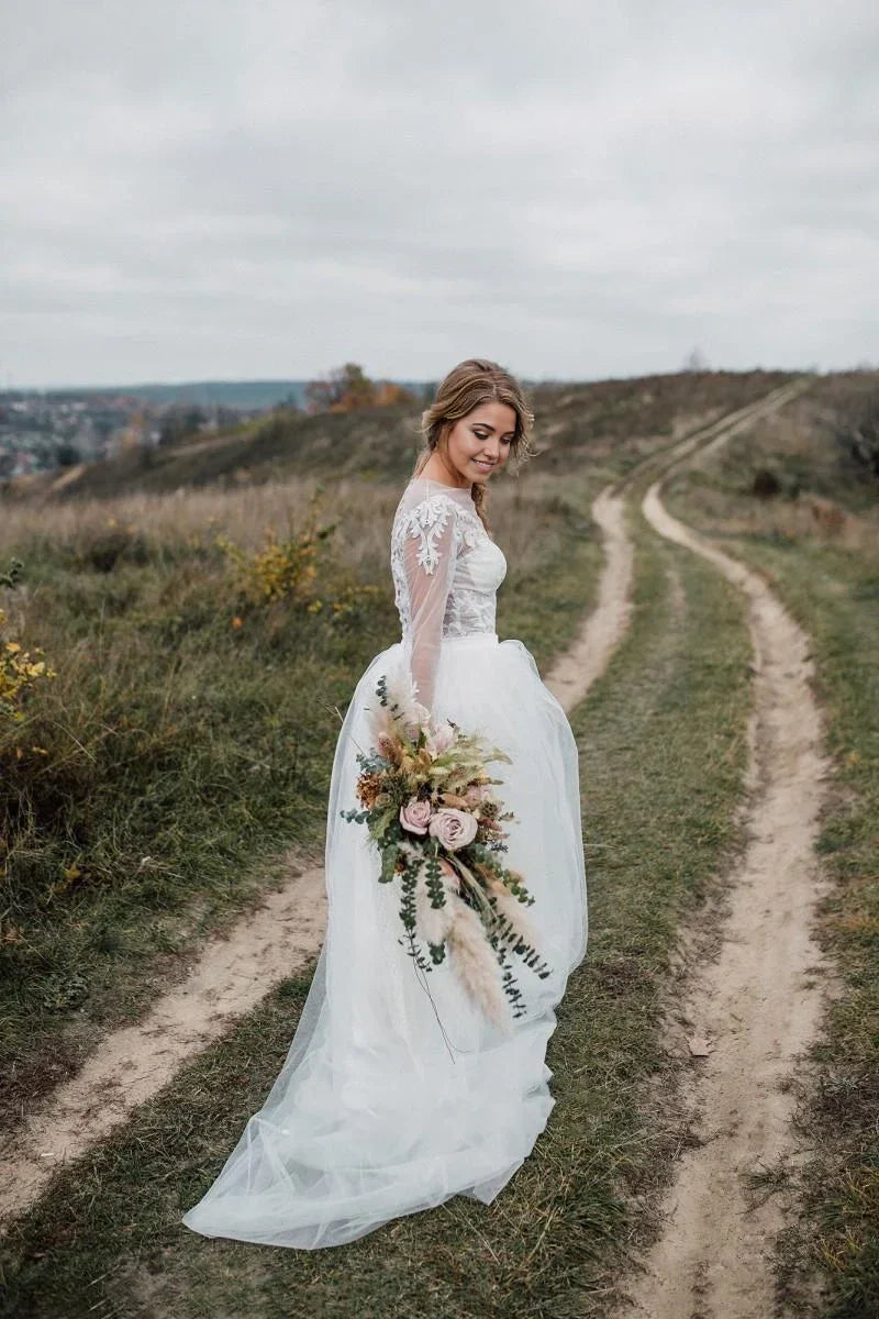 Back view of a two-piece wedding dress showing the court train and lace.