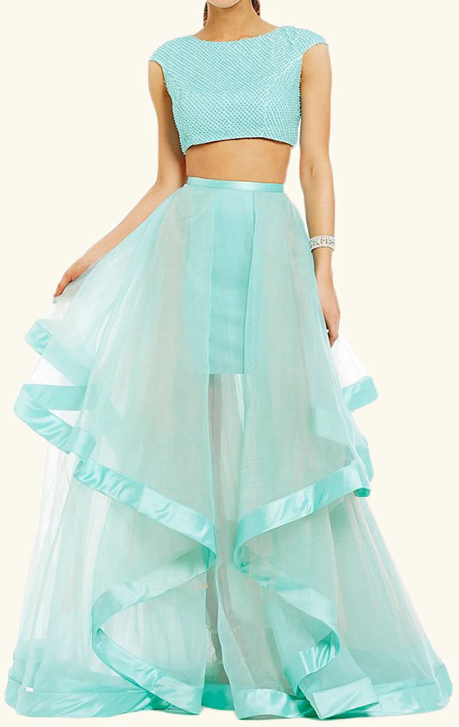 Model wearing a turquoise two-piece cap sleeve tulle prom gown, front view.