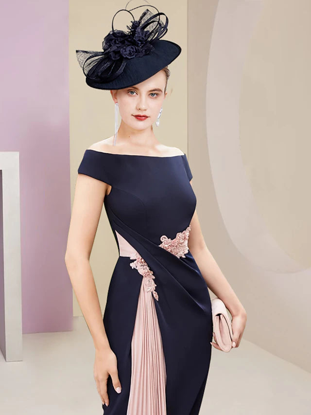 Back view of the knee-length two-piece dress showing pleats and appliques.