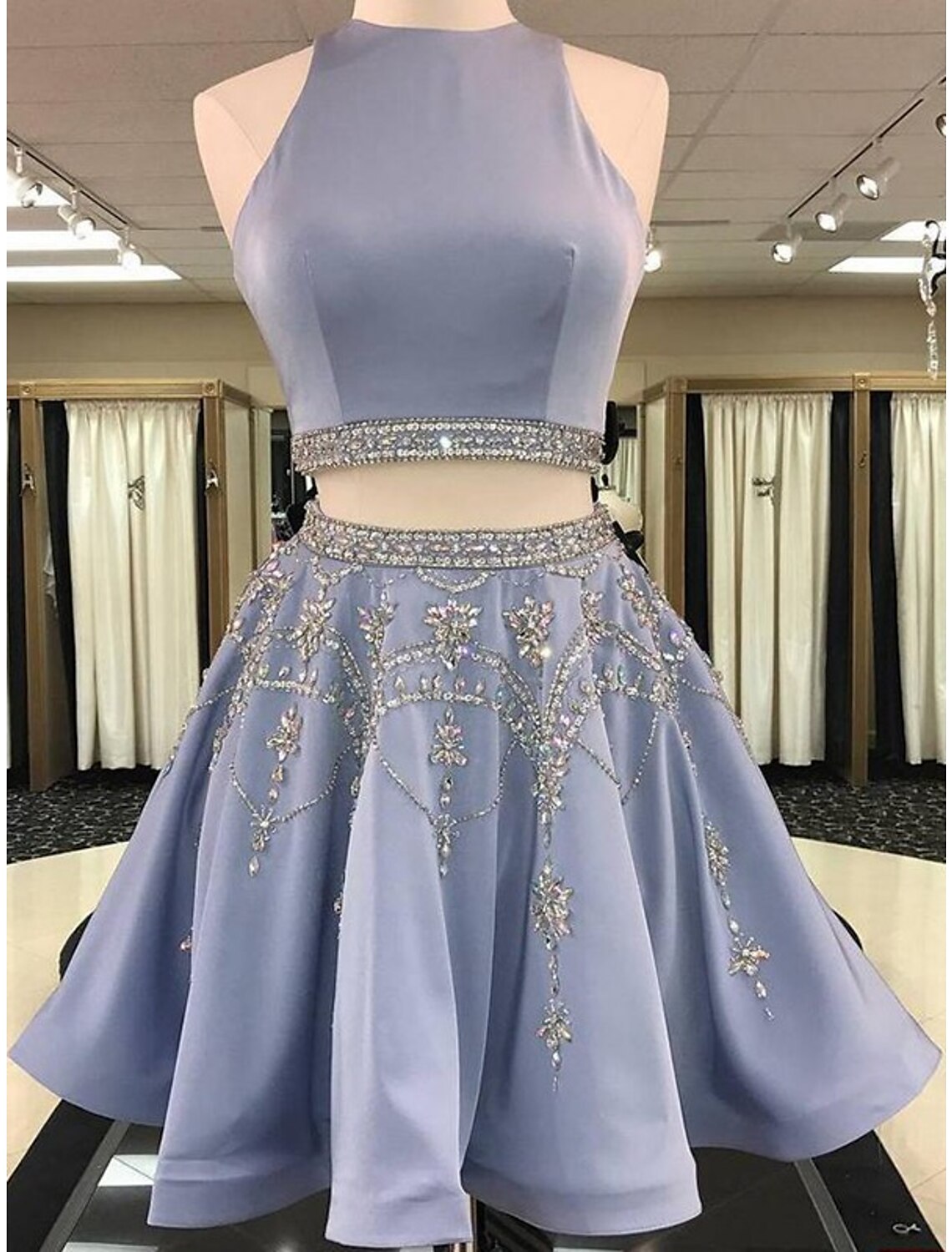 Elegant two-piece short homecoming dress in satin with jewel neck and beading.