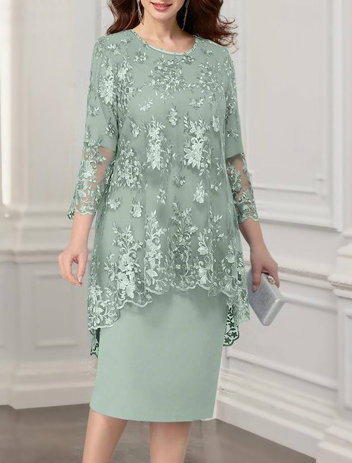 Full view of a woman in a tea length lace chiffon jacket dress.
