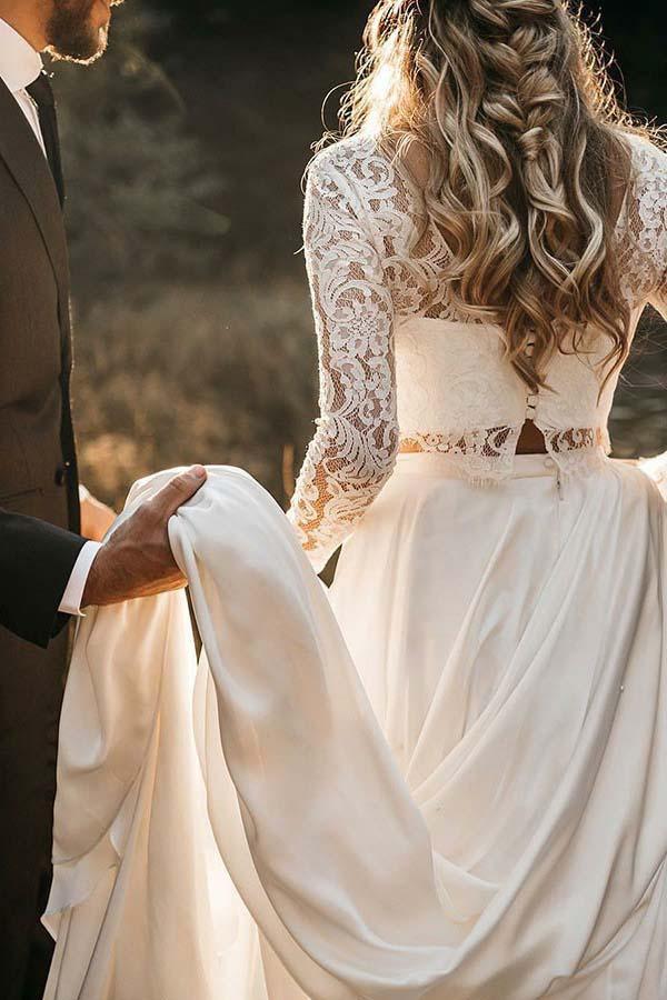 Close-up of the delicate lace top and flowing chiffon skirt of the wedding dress.
