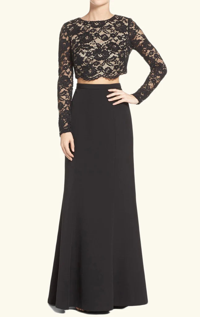 Model wearing a two-piece long sleeve lace prom dress in blue.