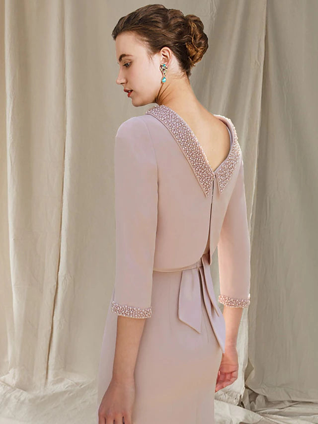 Side view of the two-piece mermaid dress, showing the tea-length high-low hem and beaded jacket.