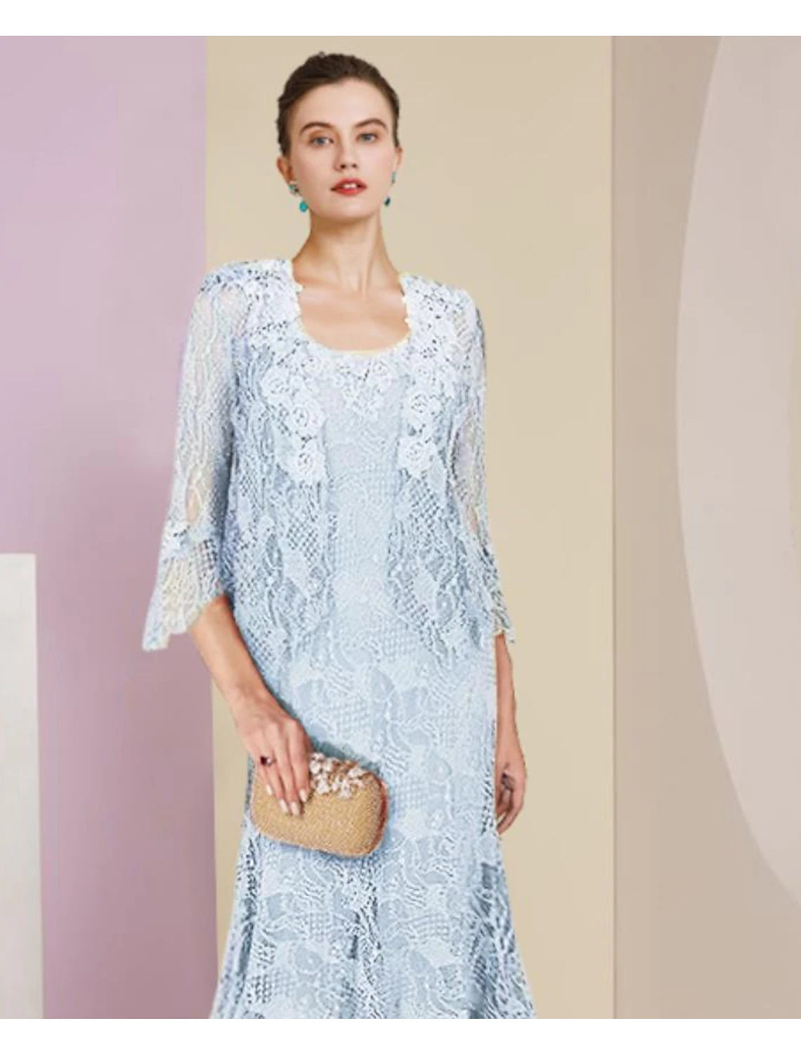 Back view of a two-piece mermaid tea length dress with a high-low hem and a matching wrap.