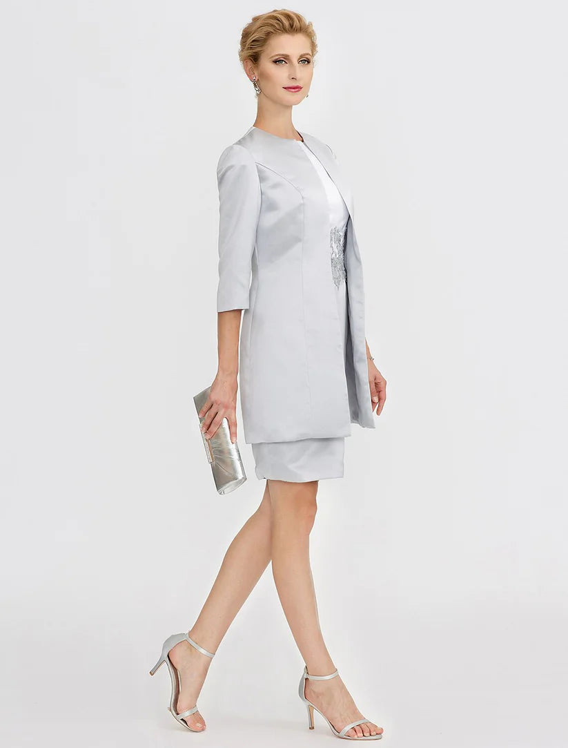 Close-up of the jewel neck and lace pleats on the satin Mother of the Bride dress.