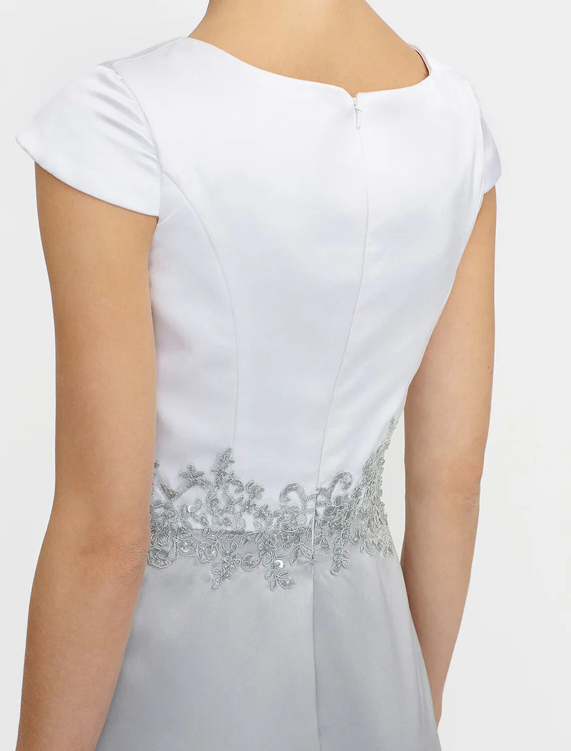 Detail of the satin fabric and delicate lace pleats on the Mother of the Bride gown.