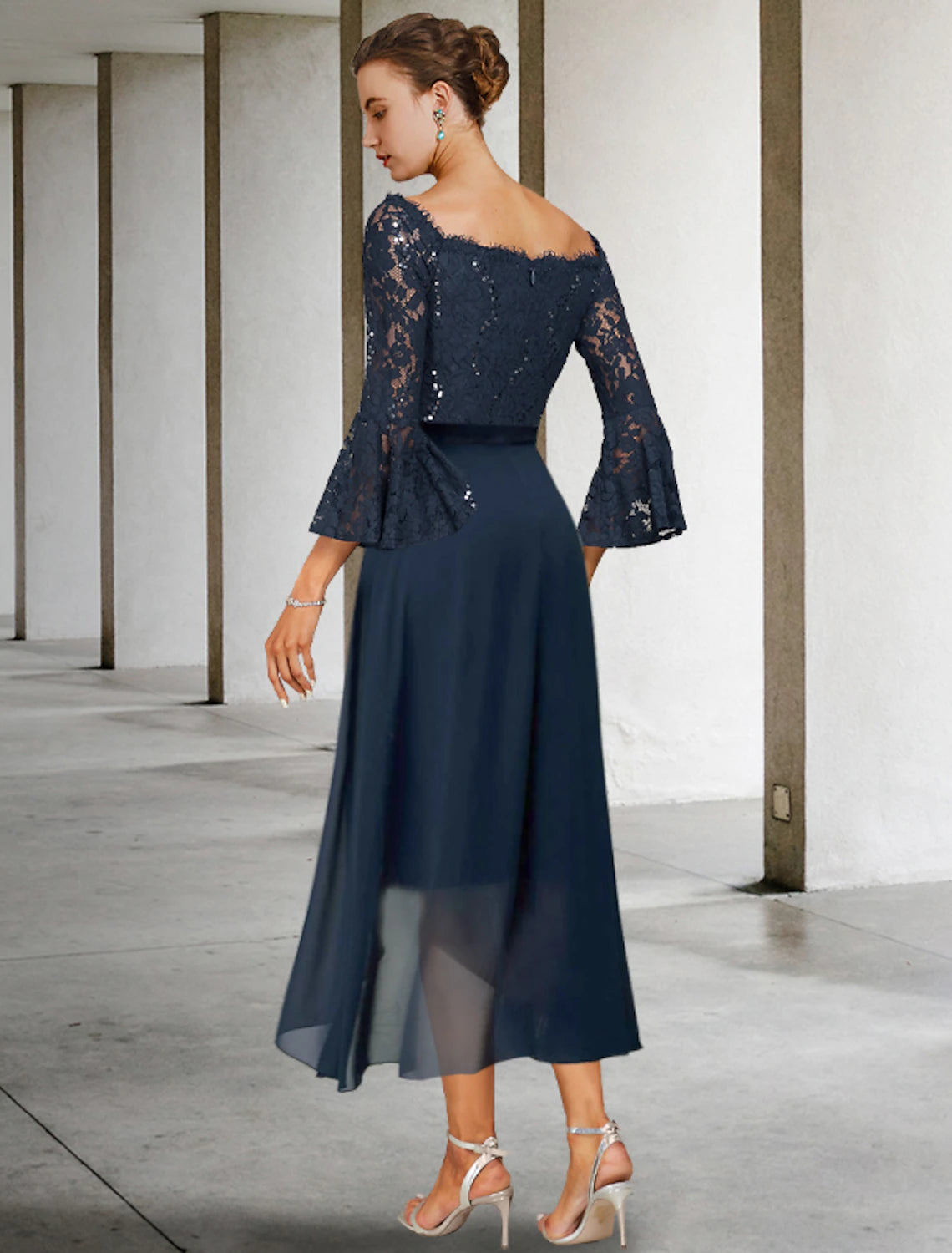 Close-up of the off-shoulder neckline and bow accent on the dress.