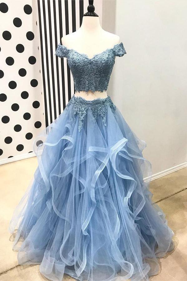 Woman wearing an elegant two-piece off-shoulder short sleeve lace maxi prom dress.