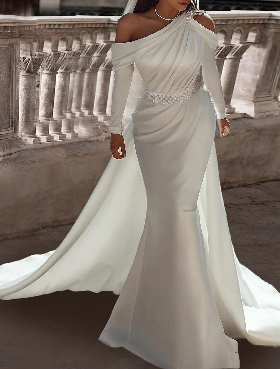 Side view of a model showcasing the floor-length satin wedding dress with a sash.