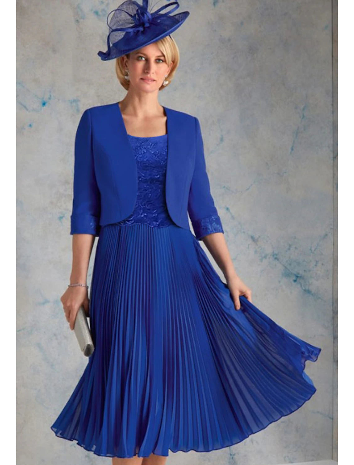 Elegant two-piece tea length chiffon dress with scoop neck and 3/4 sleeves.
