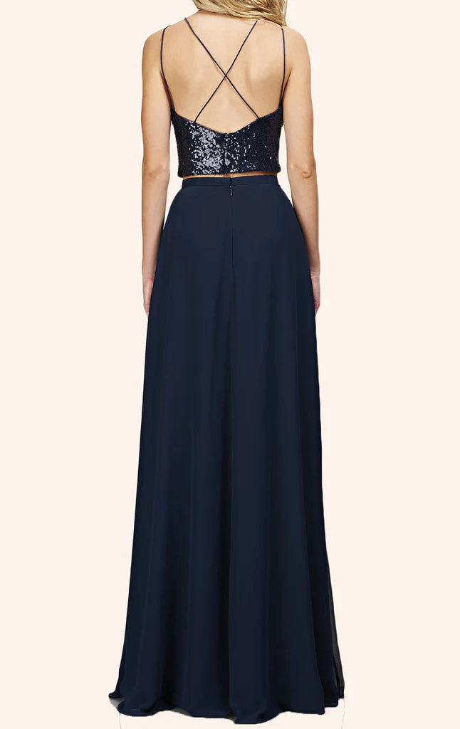 Woman wearing a two-piece sequin bodice and long chiffon skirt formal gown, side view.