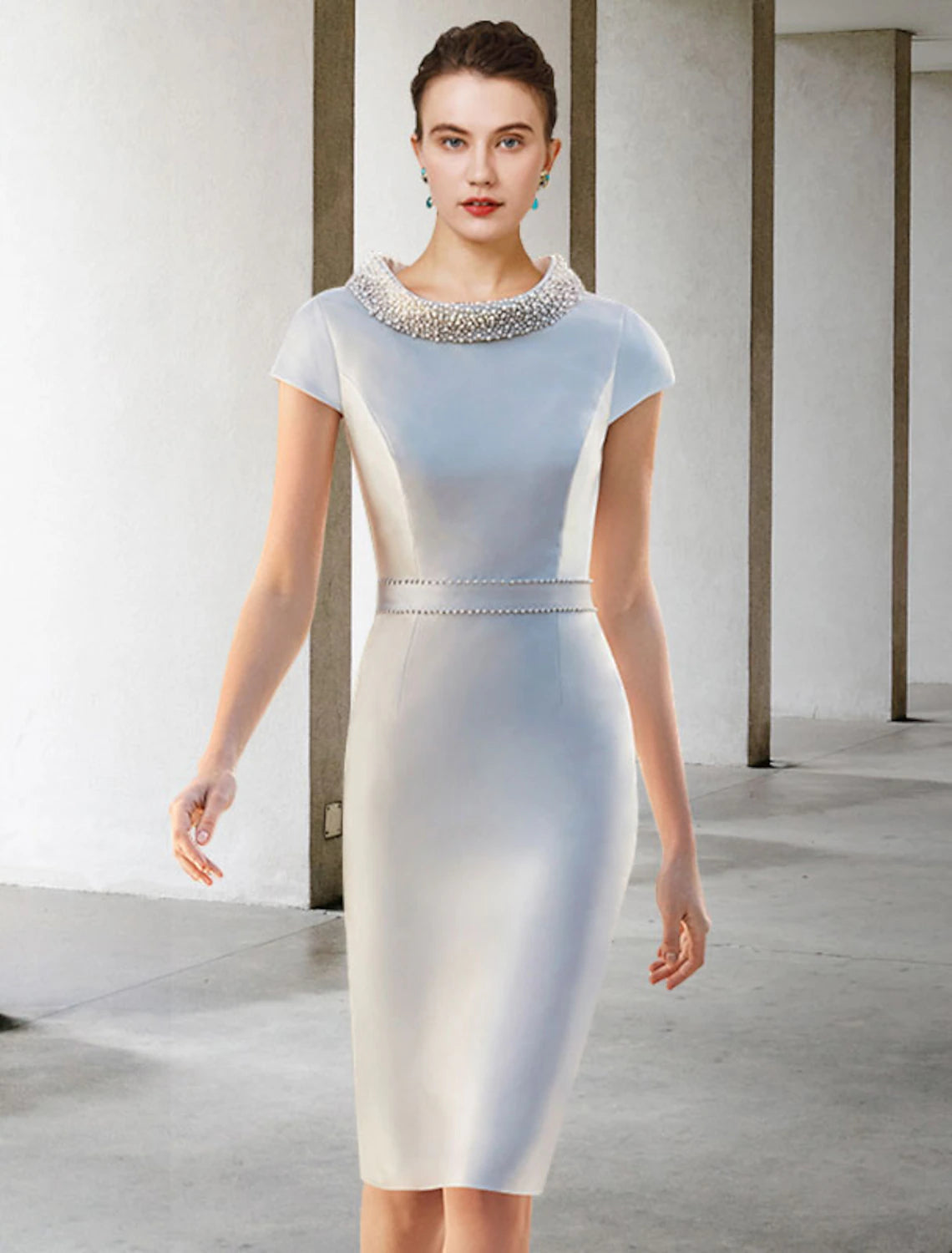 Back view of the two-piece satin dress, showing beading details.