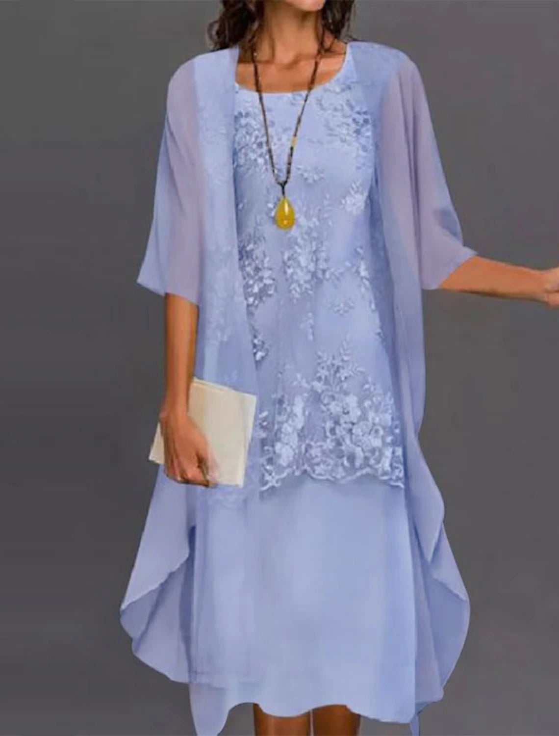 Side view of the tea length mother of the bride dress with a matching jacket.