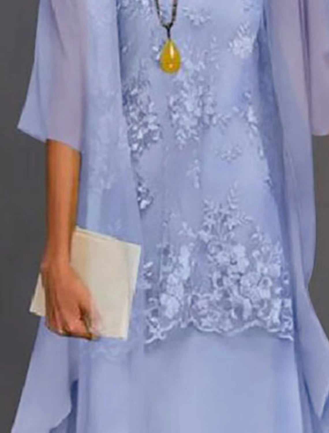 Close-up of the chiffon and lace fabric with applique details on the dress.