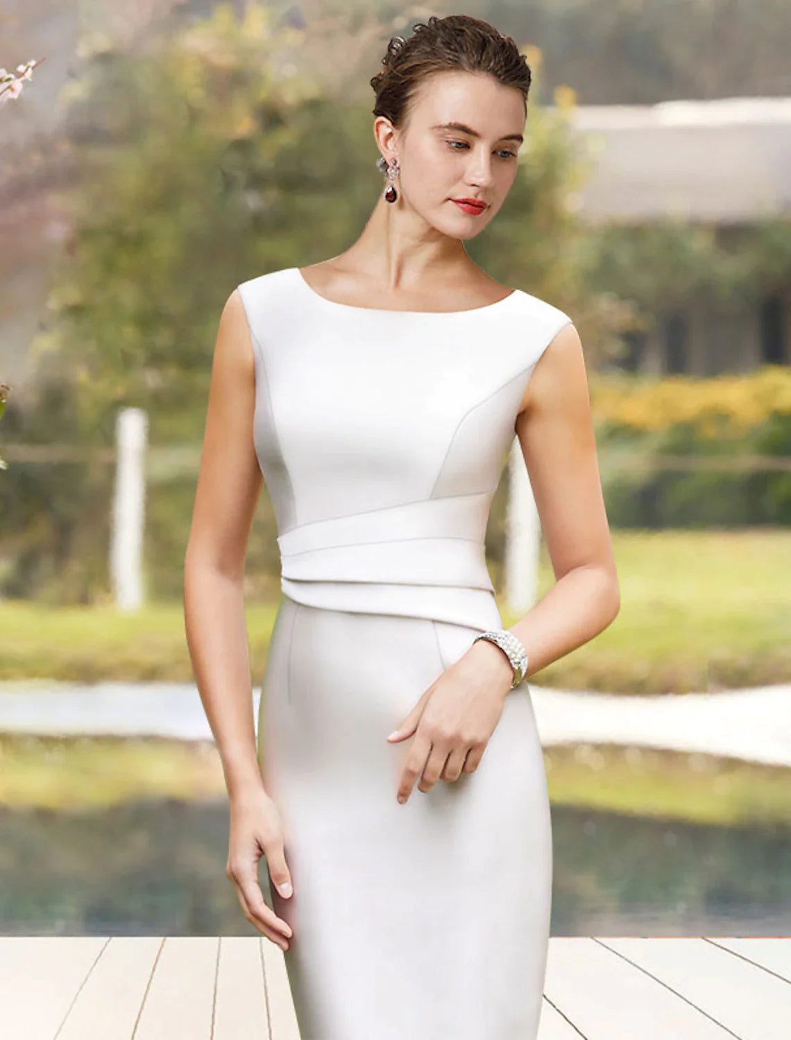 Side view of the two-piece satin dress, showing the knee-length sheath and ruffled jacket.