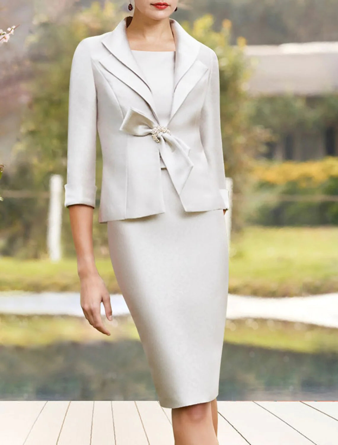 Back view of the elegant satin Mother of the Bride dress with a short jacket.