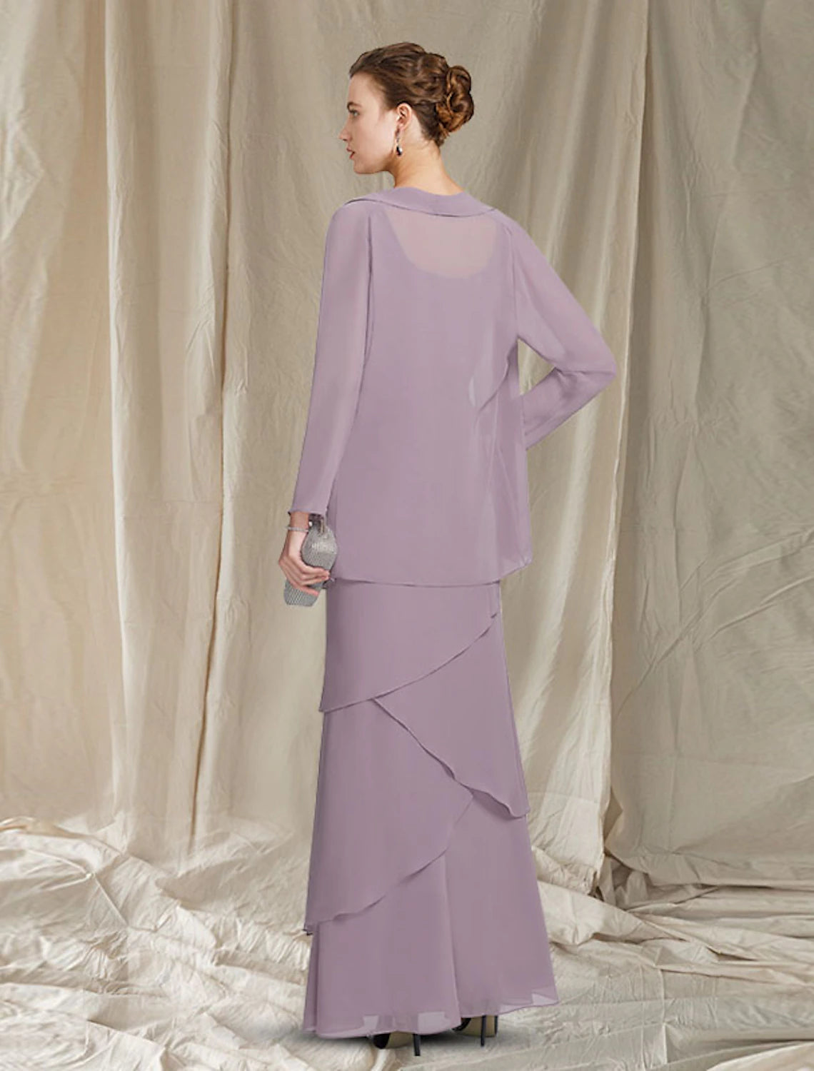 Back view of the two-piece mother of the bride dress showing flowing chiffon skirt.