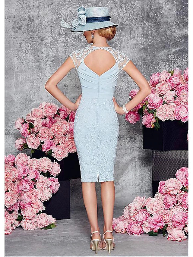 Close-up of the elegant two-piece sheath dress, highlighting the lace split front and crystal brooch.