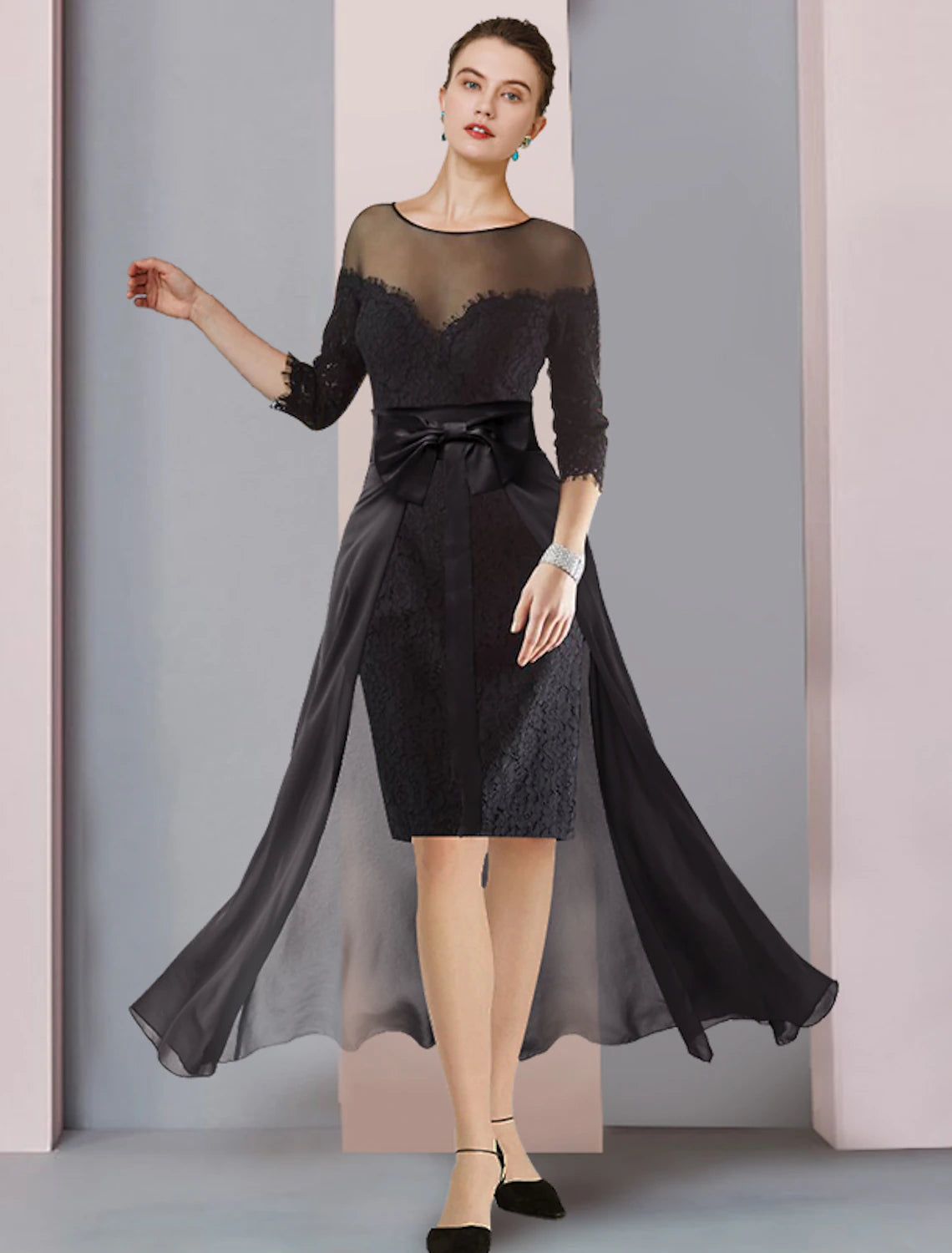 Woman wearing an elegant two-piece sheath dress with a scoop neck and lace 3/4 sleeves.