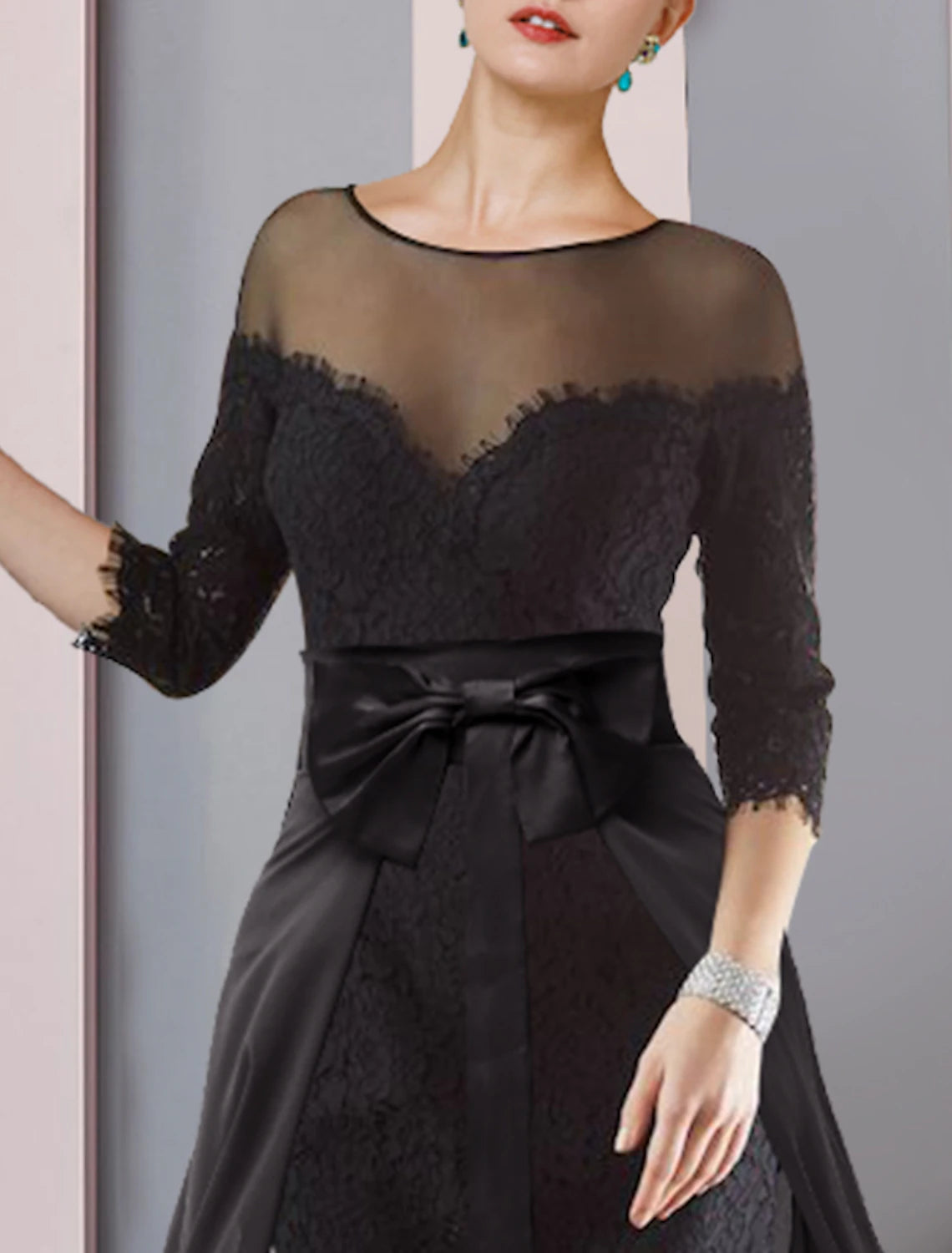 Back view of a woman in a formal two-piece knee-length dress with bow appliques.