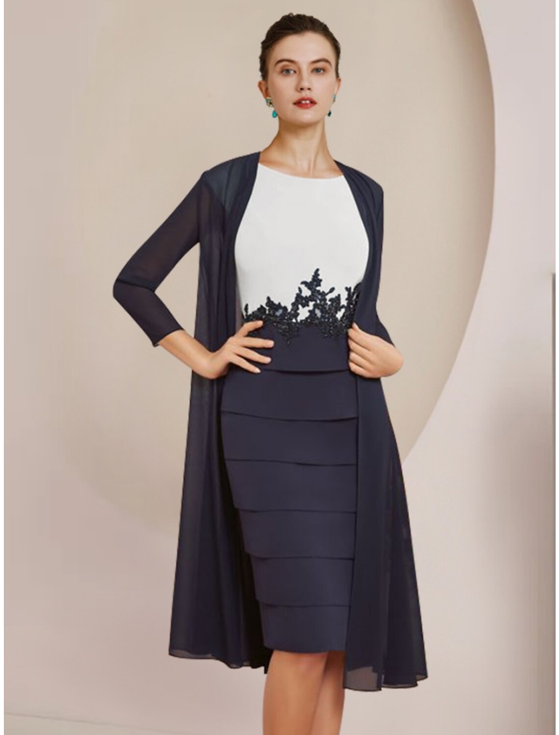 Elegant two-piece sheath dress with scoop neck, long sleeves, and knee-length hem.