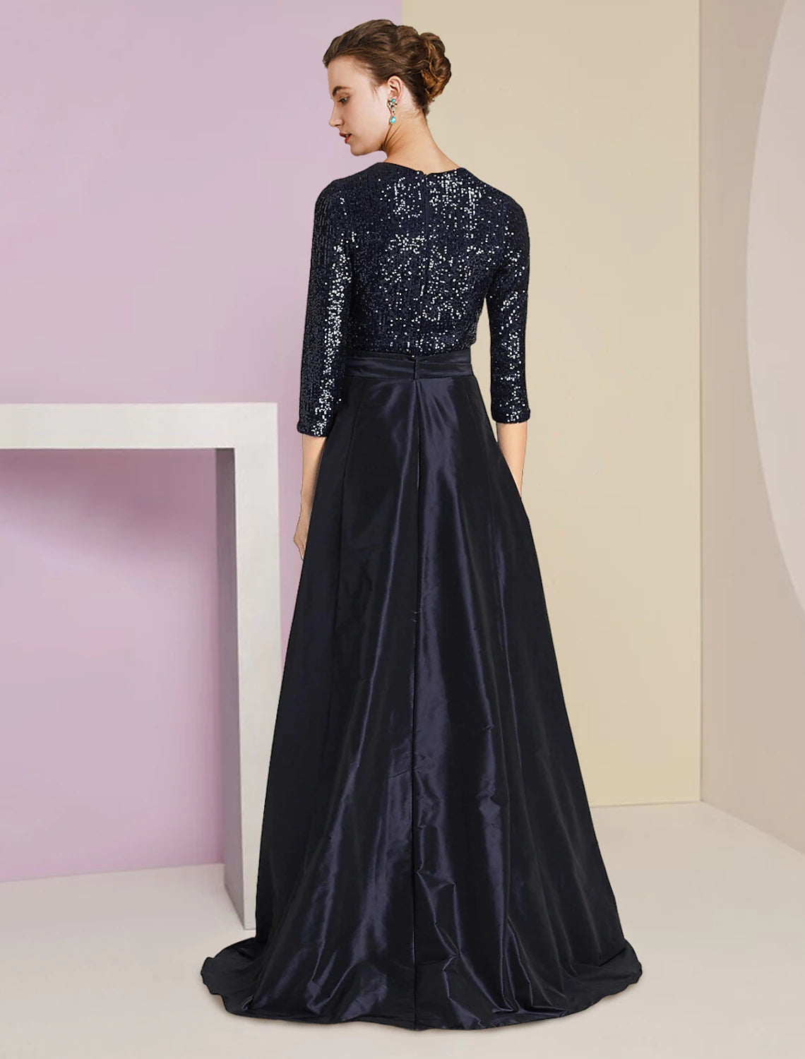 Back view of the sequined two-piece formal gown with detachable taffeta.