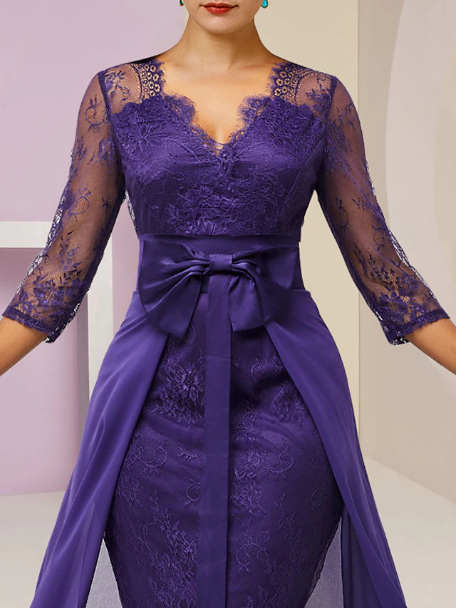 Close-up of the V-neckline and 3/4 lace sleeves on the dress.