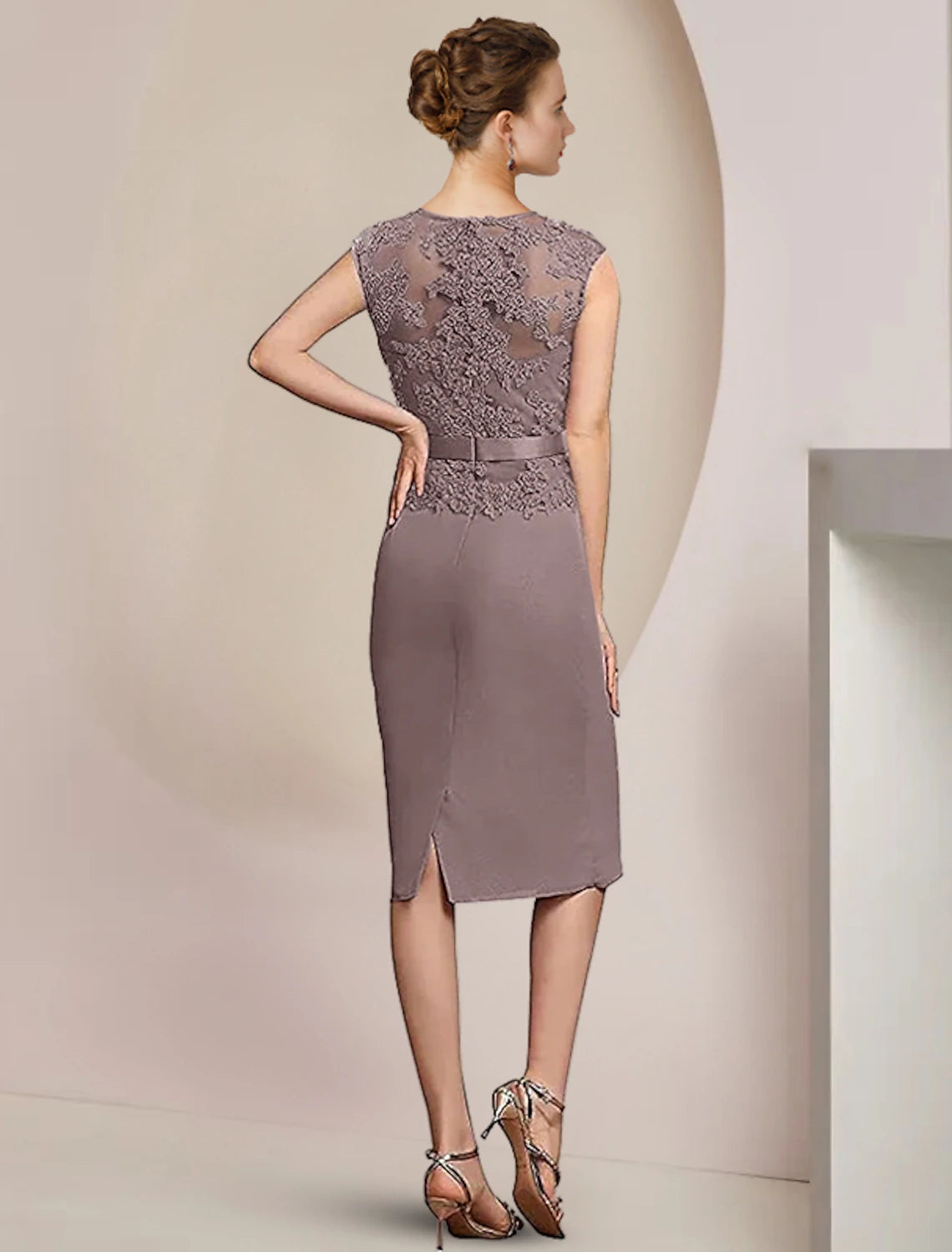 Close-up of the lace jacket with crystal brooch and appliques on the two-piece dress.