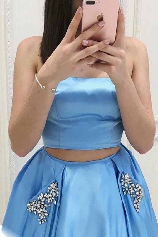 Blue satin prom dress with sweep train and pockets.
