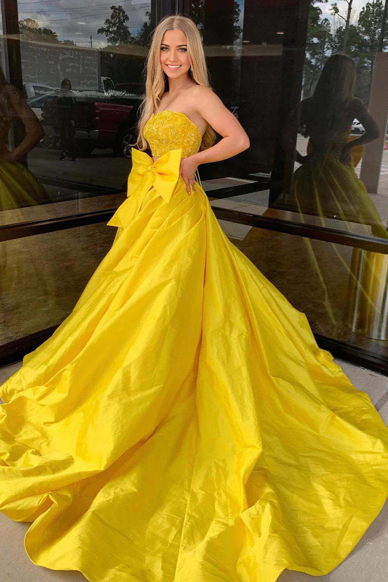 Back view of yellow two-piece strapless satin long prom dress.