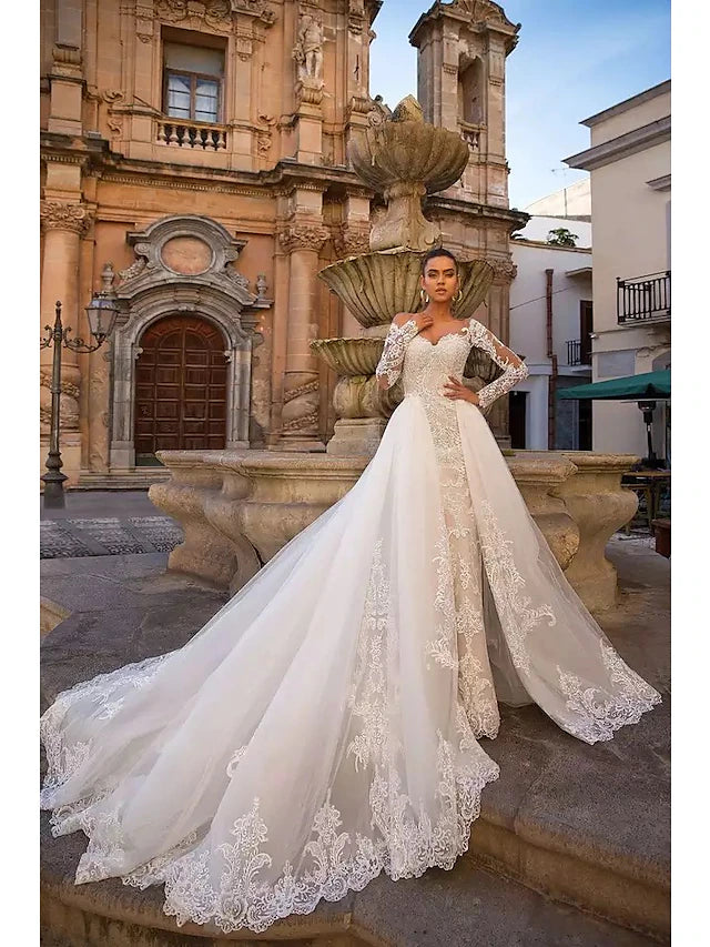 Elegant two-piece wedding dress with sweetheart neckline and long lace sleeves.