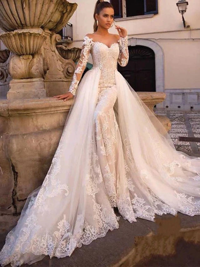 Bride wearing an elegant two-piece bridal gown with a court train.