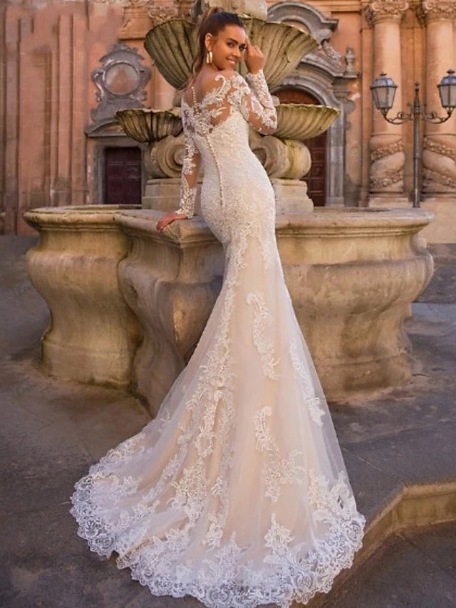 Full view of a formal engagement dress featuring lace and appliques.