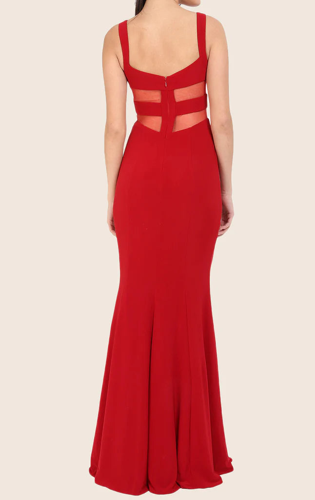 Side profile of a woman in a two-piece mermaid prom dress.