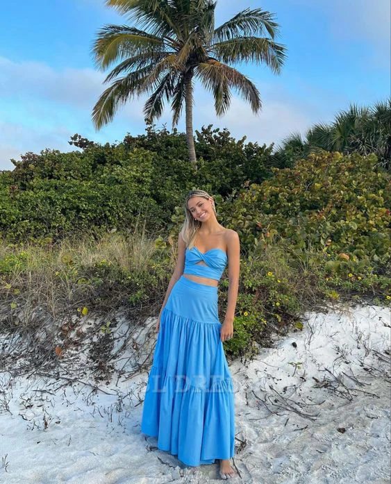 Woman wearing an elegant blue two-piece sweetheart strapless long formal dress.