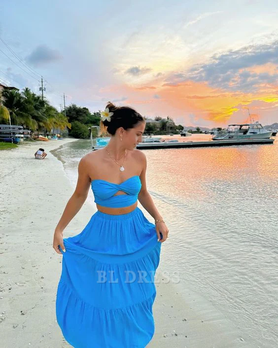 Woman posing in a blue two-piece sweetheart strapless evening gown.