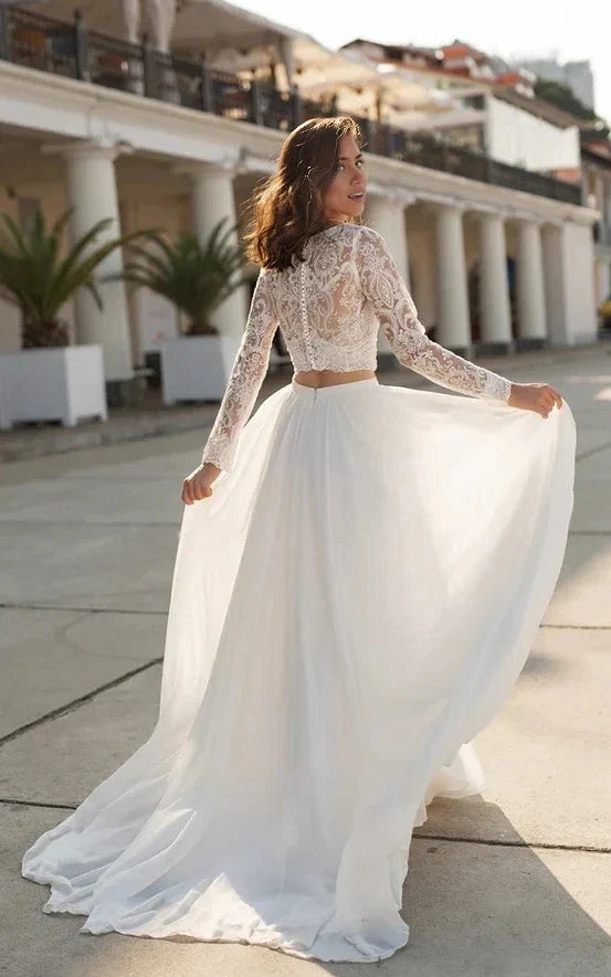 Close-up of the intricate lace detail on the V-neck and long sleeves of the wedding dress.