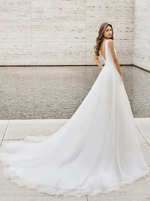 Back view of the court train on a patterned beach wedding dress.