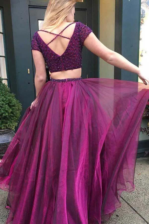 Close-up of the beaded V-neck and short sleeves on the purple tulle prom dress.