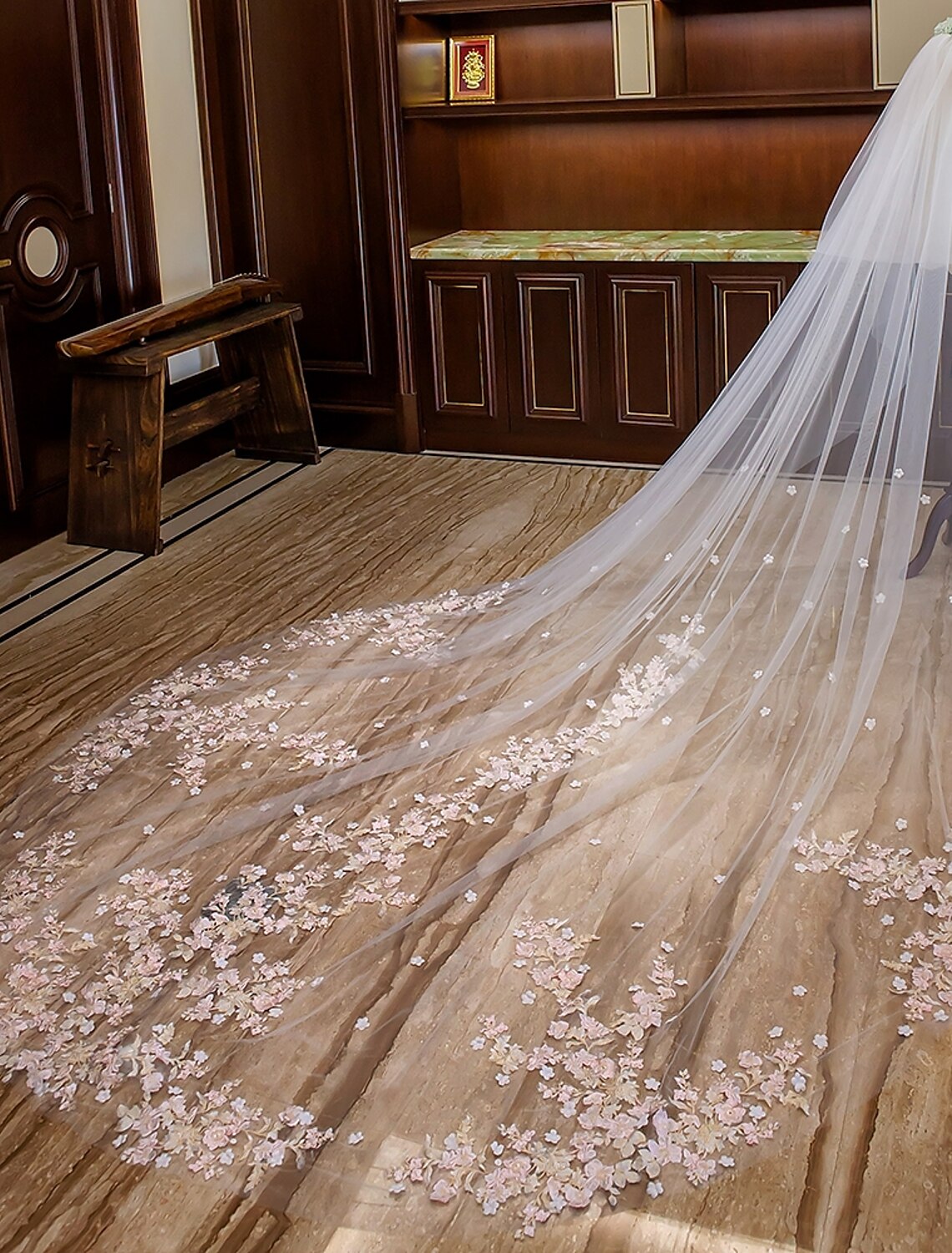 Close-up of delicate floral lace appliques on the wedding veil.
