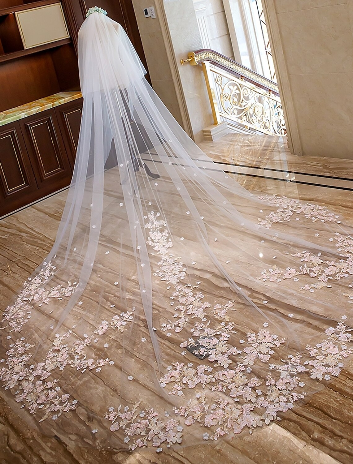 Back view of a bride showcasing the long two-tier wedding veil.