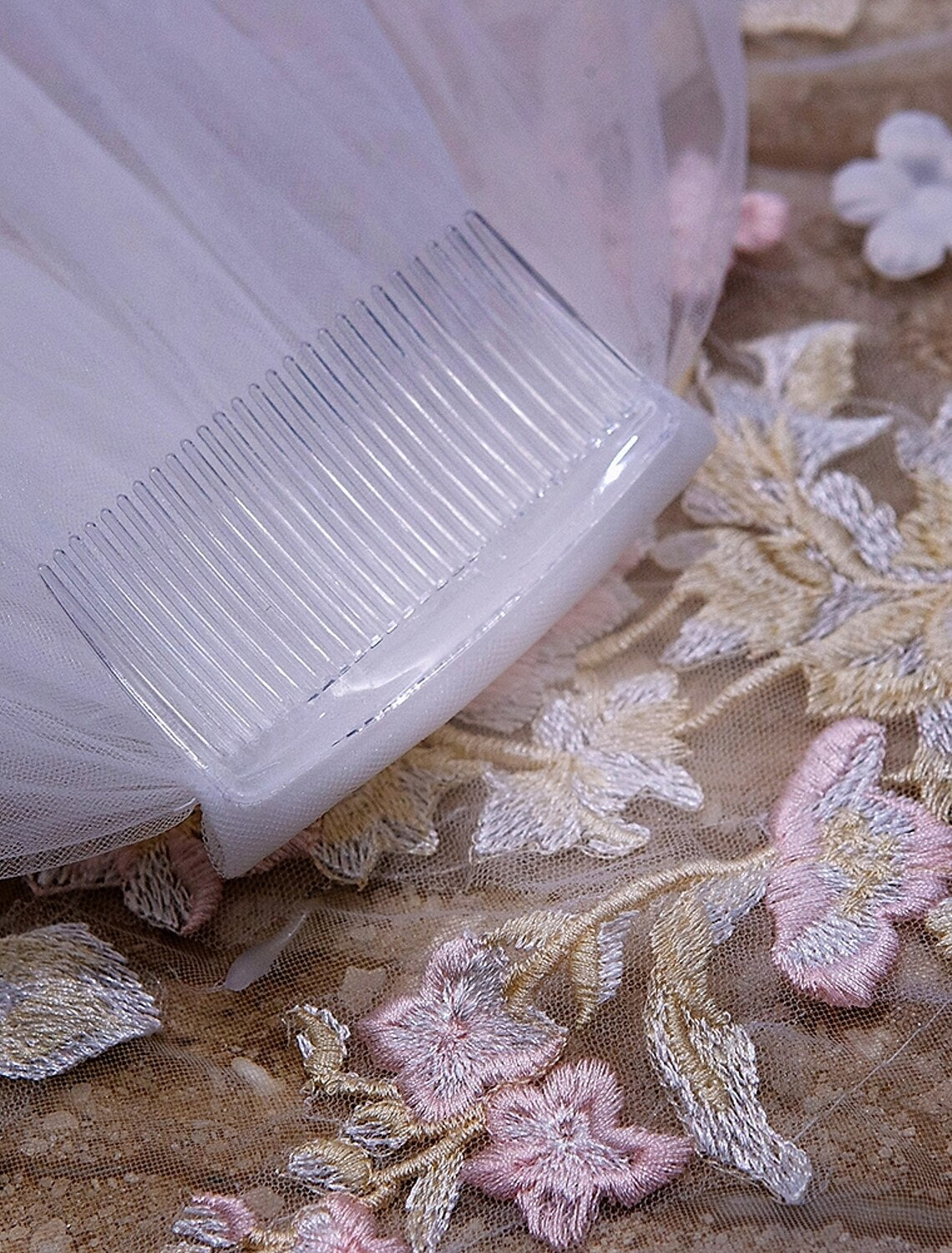Side profile of a bride with the elegant cathedral wedding veil.