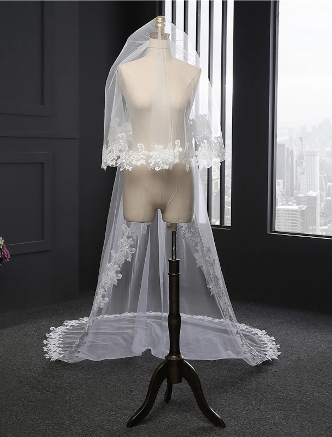 Bride from behind, wearing a cathedral-length wedding veil.