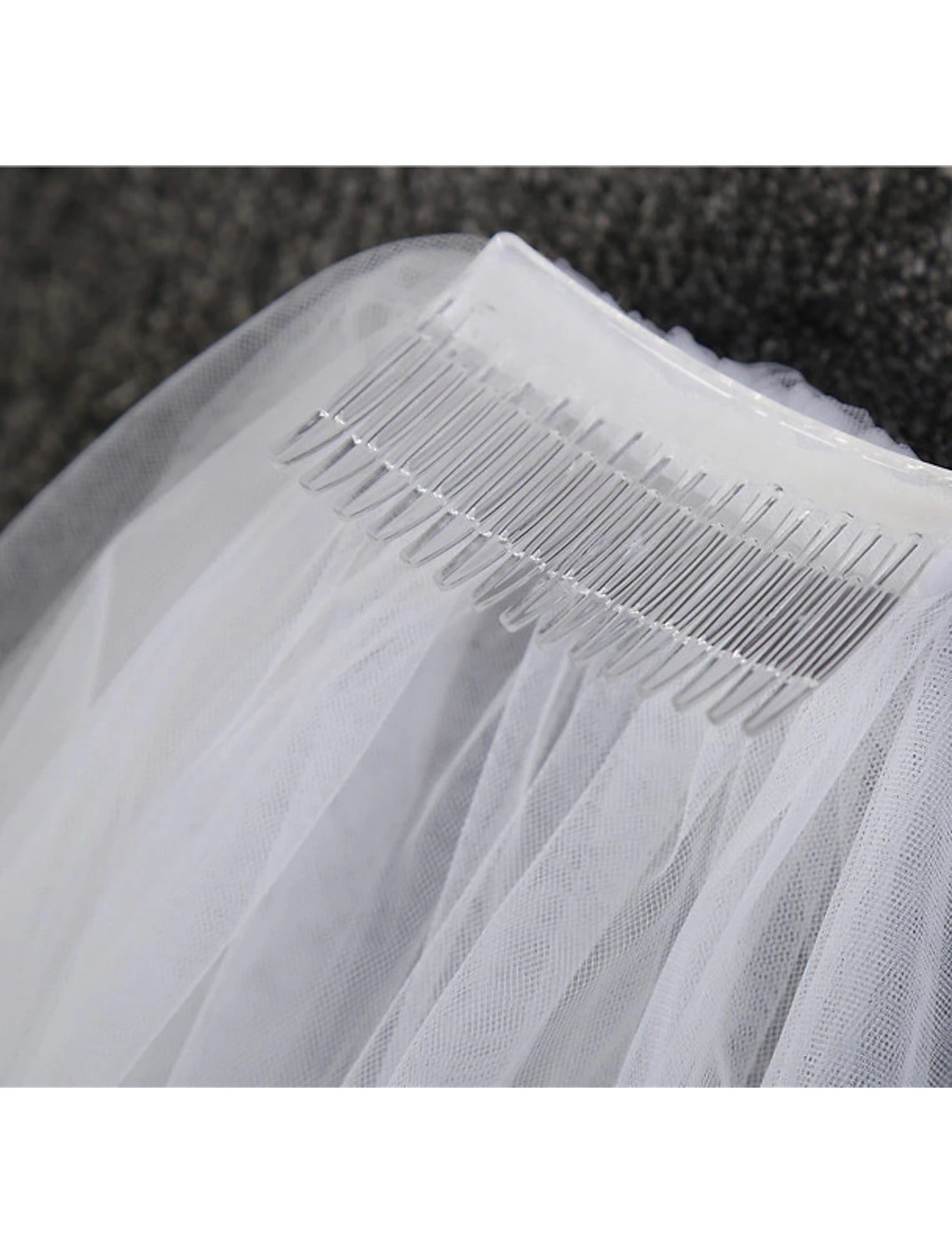Full view of a two-tier wedding veil, showcasing its length and detail.