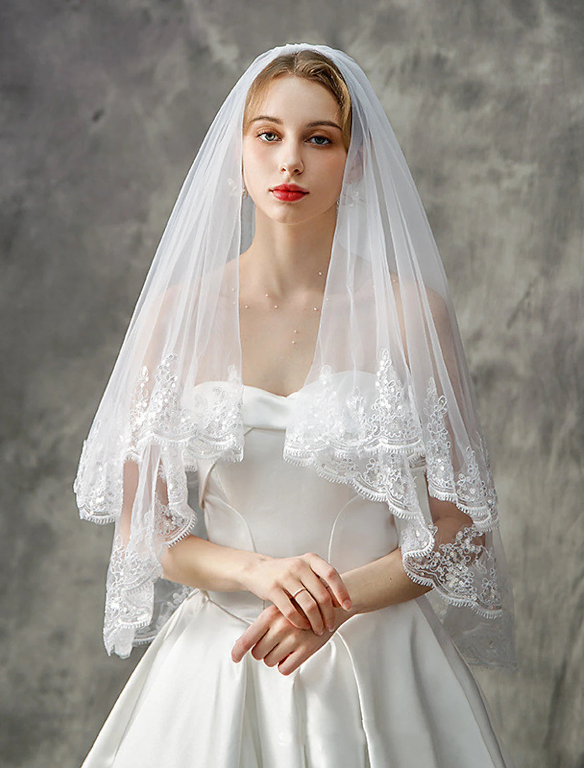 Elegant two-tier elbow wedding veil with sequin details.