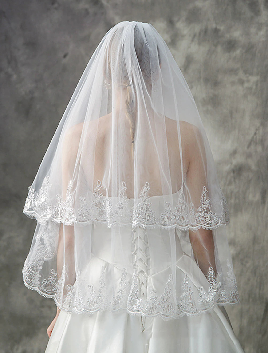 Close-up of sequin embellishments on a tulle wedding veil.