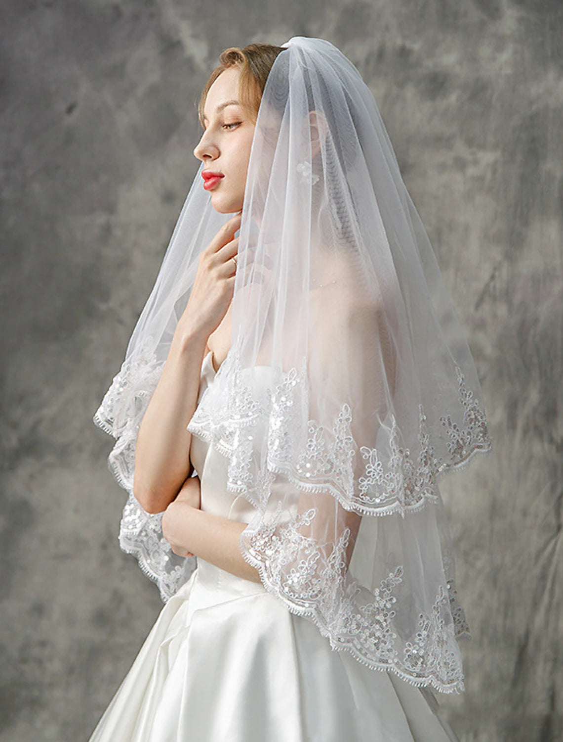 Back view of a bride wearing an elegant sequined wedding veil.